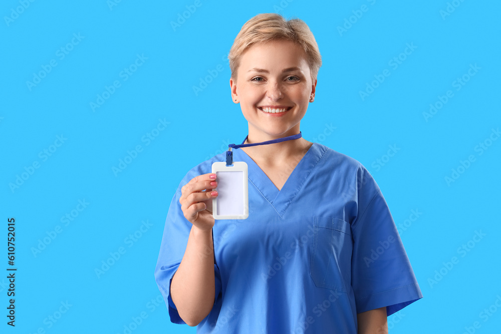 Female medical intern with badge on blue background Female medical intern with badge on blue background