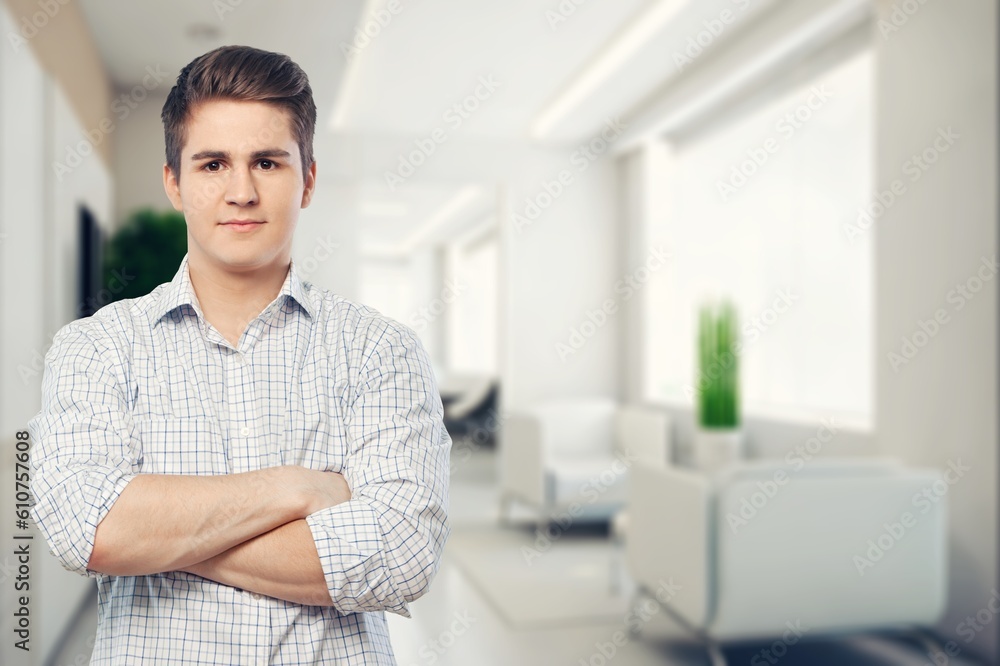 Fototapeta premium Handsome young smart man with arms crossed