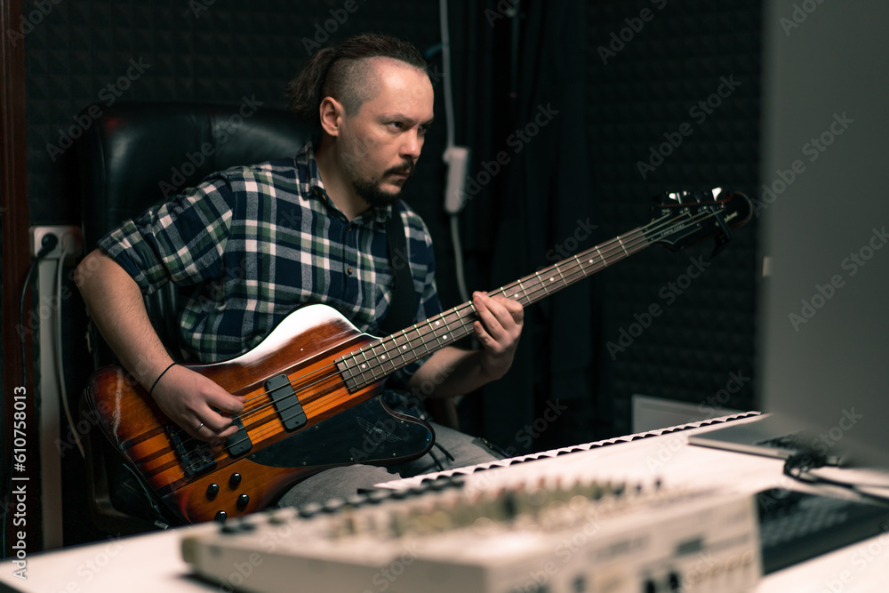 Obraz premium rock performer with electric guitar in recording studio recording playing own track musical instrument strings melody