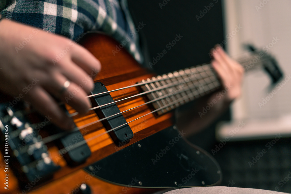 Obraz premium rock performer with electric guitar in recording studio recording playing own track creating song musical instrument strings close-up