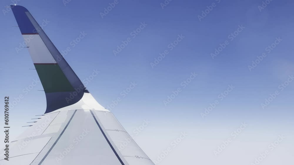 Airplane flight. View from the window on the wing of an airplane flying above the clouds. Air travel. High quality 4k footage Airplane flight. View from the window on the wing of an airplane flying above the clouds. Air travel. High quality 4k footage