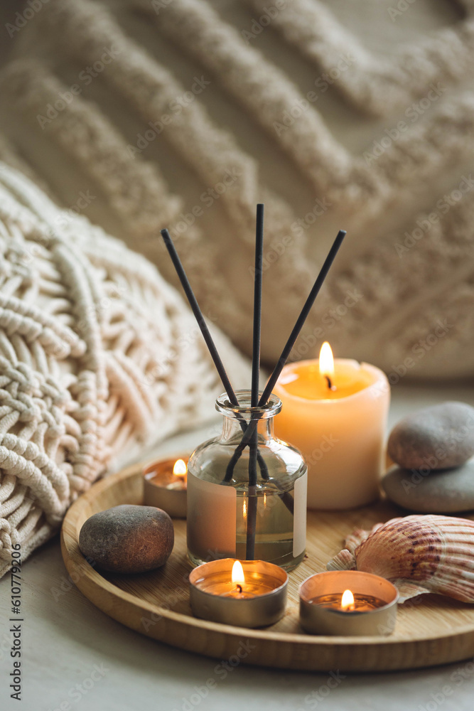 Burning candles on bamboo tray, cozy home atmosphere. Relaxation, detention zone in the living or bedroom. Stones, sea shells as decor. Apartment natural aroma diffusor with ocean breeze fragrance. Burning candles on bamboo tray, cozy home atmosphere. Relaxation, detention zone in the living or bedroom. Stones, sea shells as decor. Apartment natural aroma diffusor with ocean breeze fragrance.