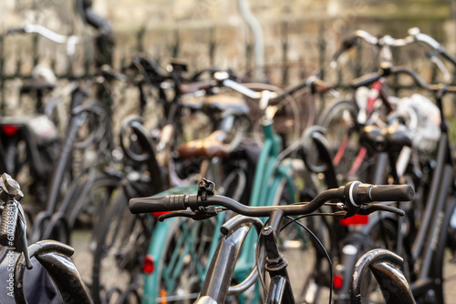 Selective blur on the handlebar of bicycles, parked in a bicycle parking, in Maastricht city center. Cycling and bikes are a symbol of netherlands.