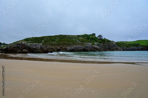 View on Playa de Borizo in Celorio, Green coast of Asturias, North Spain with sandy beaches, cliffs, hidden caves, green fields and mountains.
