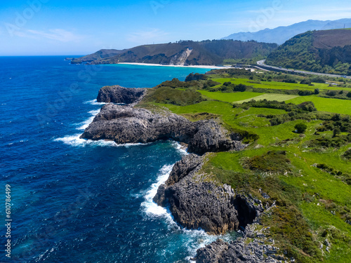 Aerial view on coastline of Green coast of Asturias, North Spain with sandy beaches, cliffs, hidden caves, green fields and mountains. photo