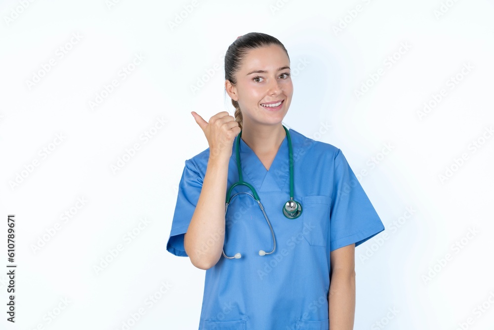 Impressed young caucasian doctor woman wearing medical uniform over white background point back empty space Impressed young caucasian doctor woman wearing medical uniform over white background point back empty space