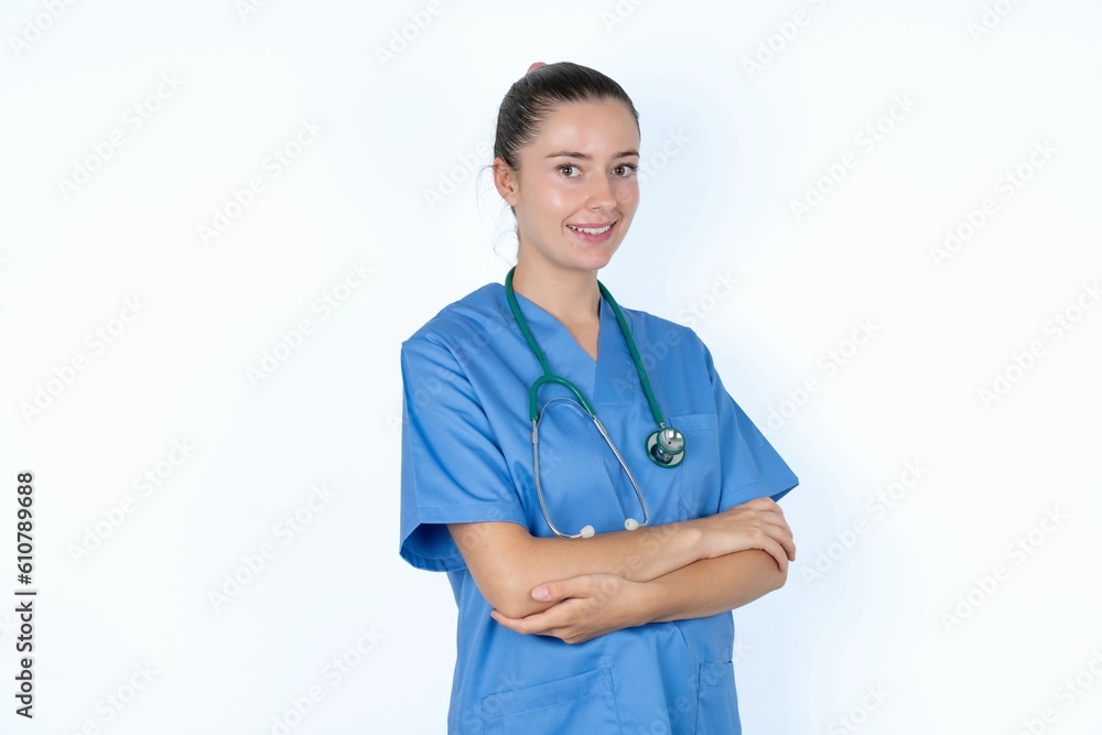 Portrait of young caucasian doctor woman wearing medical uniform over white background standing with folded arms and smiling Portrait of young caucasian doctor woman wearing medical uniform over white background standing with folded arms and smiling