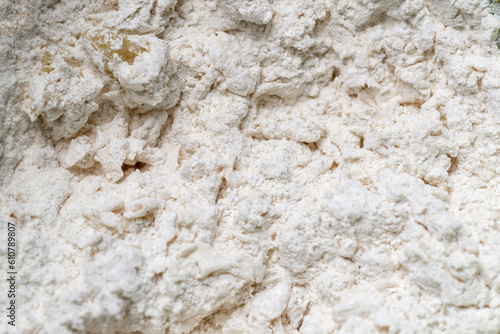 Mixture of flour and water. Preparation, kneading of dough for making bread. Macro close-up.
