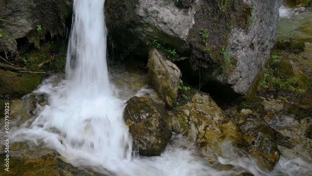 Water falls down on mountain rocks Water falls down on mountain rocks