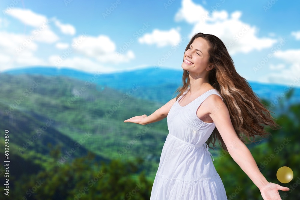 Happy young female traveler relaxing on mountains Happy young female traveler relaxing on mountains