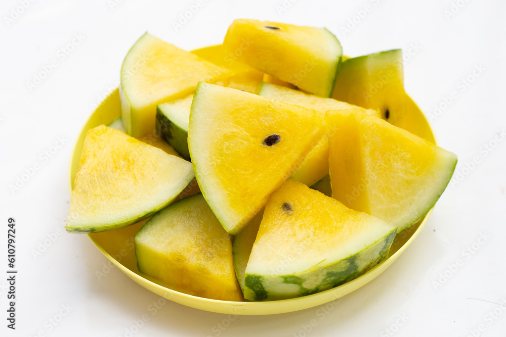 Yellow watermelon slices in plate on white background. Yellow watermelon slices in plate on white background.