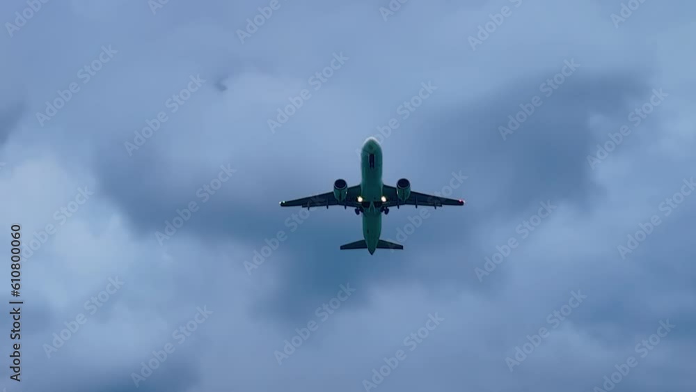 Large passenger airplane, airliner is taking off, gaining altitude and flying in the gloomy cloudy gray sky in the evening. Transportation, journey, flight and tourism concept Large passenger airplane, airliner is taking off, gaining altitude and flying in the gloomy cloudy gray sky in the evening. Transportation, journey, flight and tourism concept