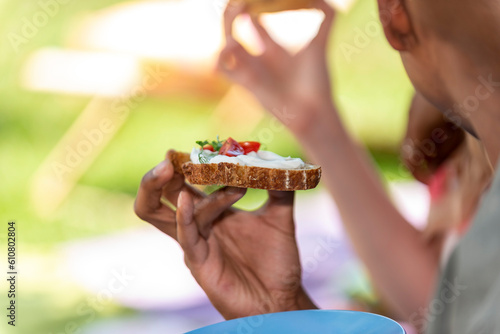 man is holding an appetizer in his hand