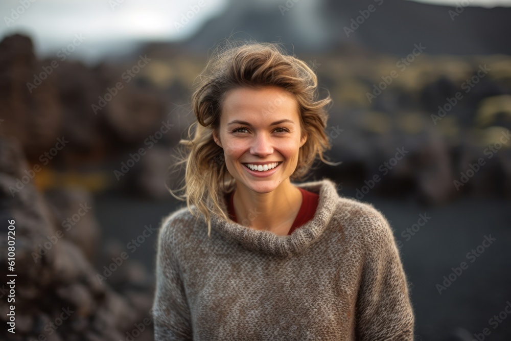 Portrait of a smiling woman standing in front of volcanic landscape on a sunny day Portrait of a smiling woman standing in front of volcanic landscape on a sunny day