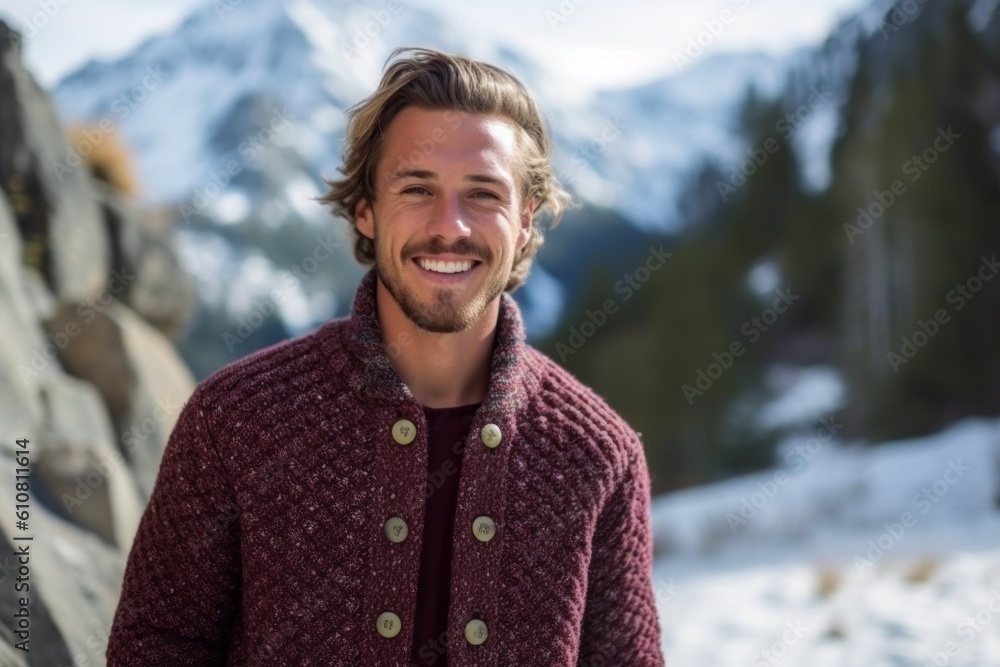 Portrait of handsome man smiling at camera while standing against snow covered mountains Portrait of handsome man smiling at camera while standing against snow covered mountains