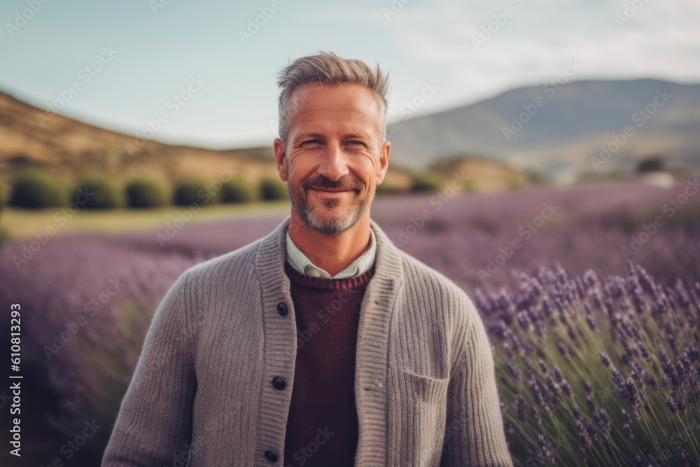 Portrait of handsome middle-aged man standing in lavender field Portrait of handsome middle-aged man standing in lavender field