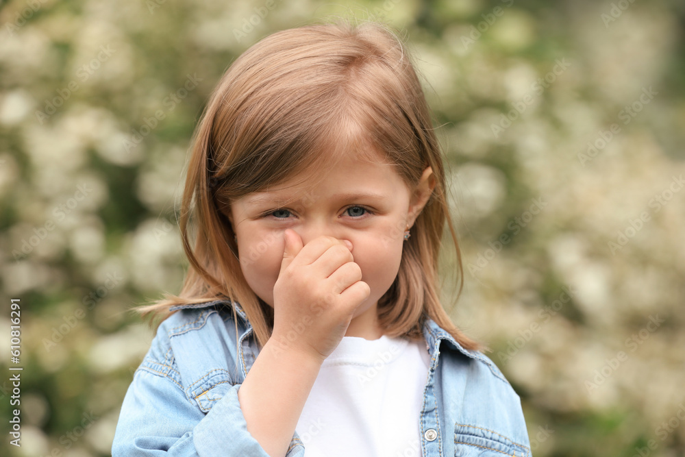 Little girl suffering from seasonal spring allergy outdoors Little girl suffering from seasonal spring allergy outdoors