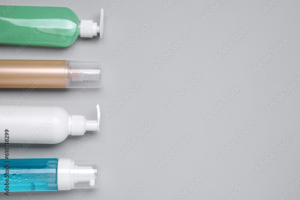 Different cleansers on light grey background, flat lay and space for text. Cosmetic product Different cleansers on light grey background, flat lay and space for text. Cosmetic product