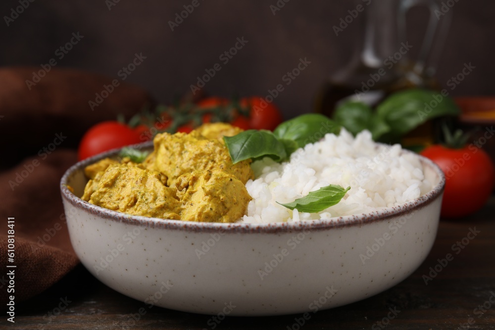 Delicious rice and chicken with curry sauce on wooden table, closeup Delicious rice and chicken with curry sauce on wooden table, closeup