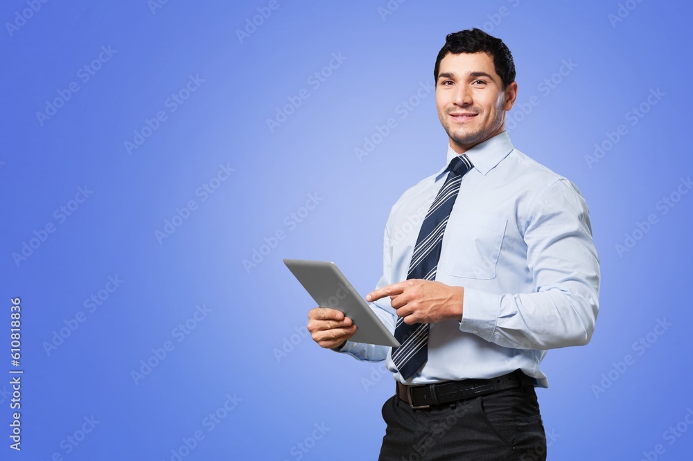 Cheerful young businessman holding digital tablet computer Cheerful young businessman holding digital tablet computer