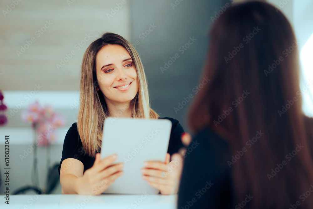 Receptionist Holding Tablet PC Welcoming a New Client. Front desk officer clerk greeting guests in a hotel reception
Receptionist Holding Tablet PC Welcoming a New Client. Front desk officer clerk greeting guests in a hotel reception