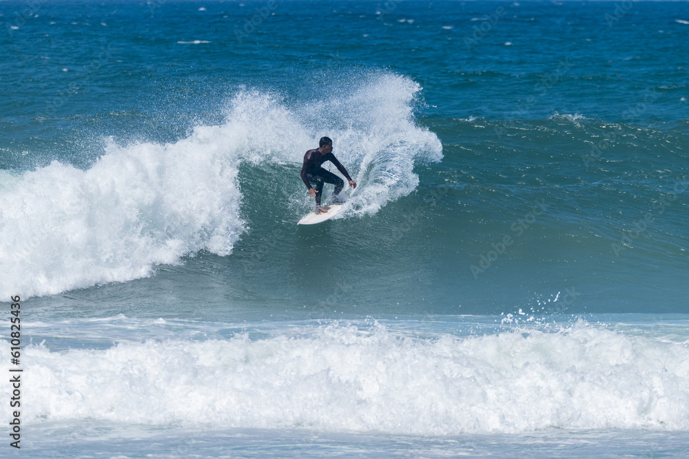 Surfer riding waves in Furadouro Beach Surfer riding waves in Furadouro Beach