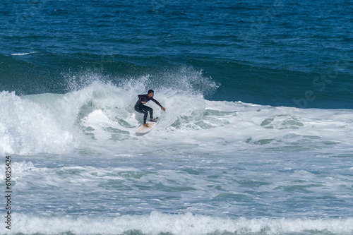 Surfer riding waves in Furadouro Beach © homydesign