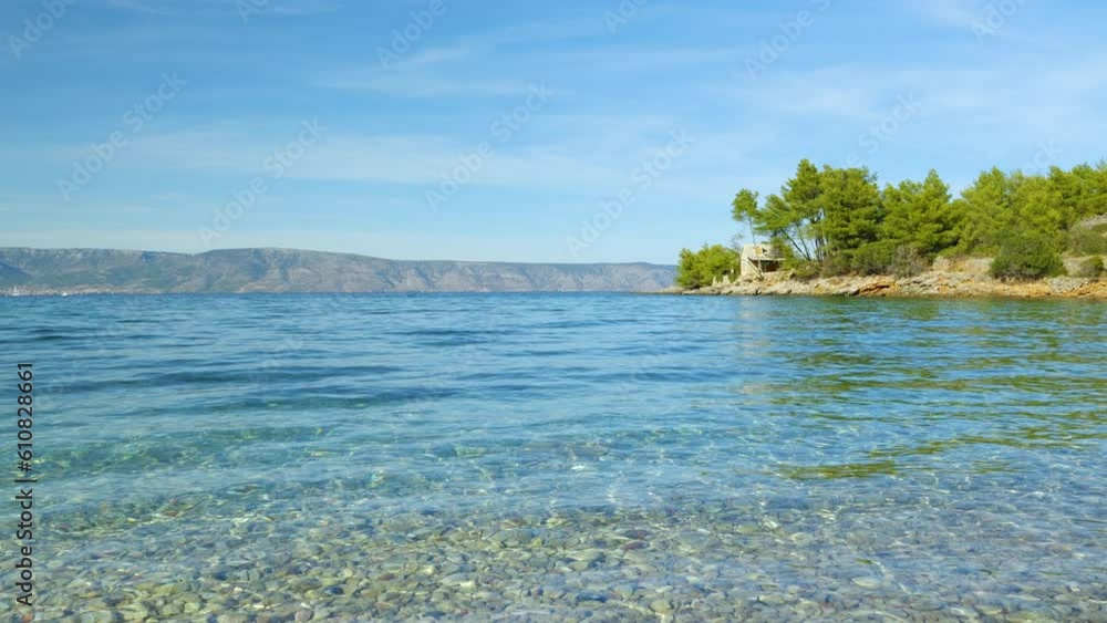 SLOW MOTION: Relaxing holiday view of crystal wavy sea along beautiful coast. Visible pebbly seabed through incredibly clean and clear undulating Adriatic Sea. Stunning destination for summer vacation SLOW MOTION: Relaxing holiday view of crystal wavy sea along beautiful coast. Visible pebbly seabed through incredibly clean and clear undulating Adriatic Sea. Stunning destination for summer vacation