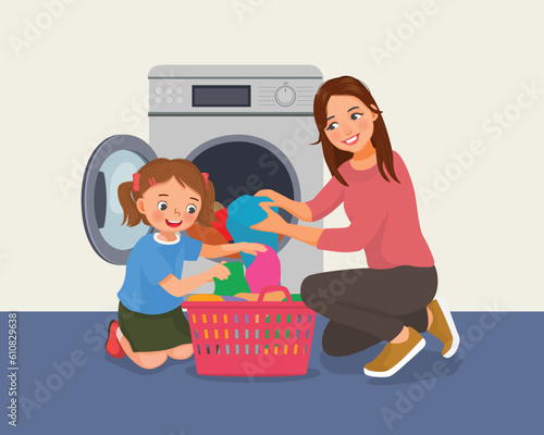 Cute little girl helping her mother doing laundry with washing machine
