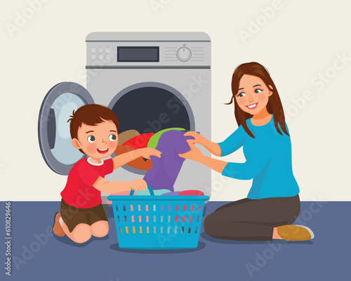 Cute little boy helping his mother doing laundry with washing machine