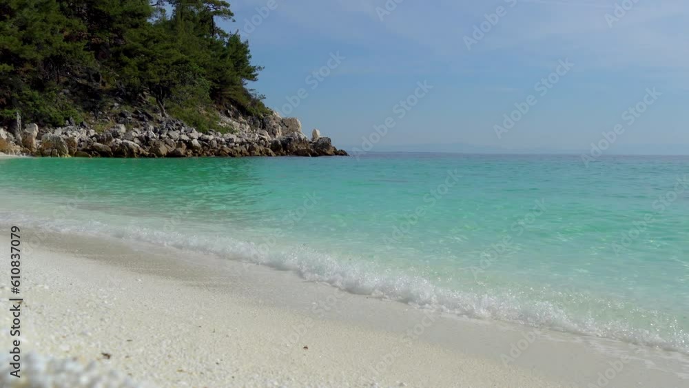 Waves Splashing On A White Pebble Beach With A Clear Blue Sky In The Background, Marble Beach, Thassos Island, Greece Waves Splashing On A White Pebble Beach With A Clear Blue Sky In The Background, Marble Beach, Thassos Island, Greece