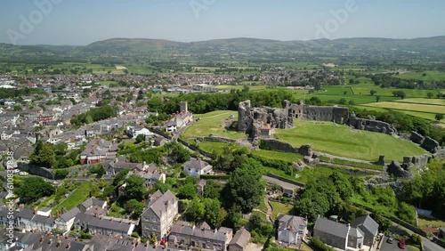 Denbigh Castle and Town Walls, Denbighshire, Wales - Aerial drone anti-clockwise distant pan from side to rear - June 23 photo