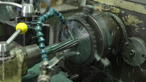 Engineering an alloy sprocket through a reaming process on a lathe machine with great precision. photo