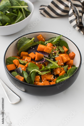  Green salad with sweet potatoes and sesame seeds. Vegan dish. Healthy eating. 