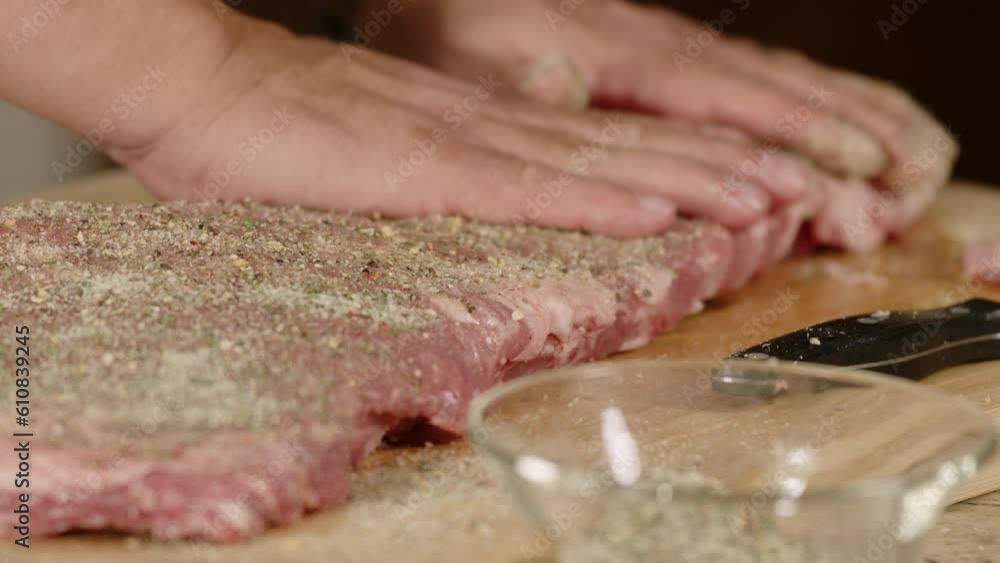 Macro close up of ribs being seasoned with spices before cooking Macro close up of ribs being seasoned with spices before cooking