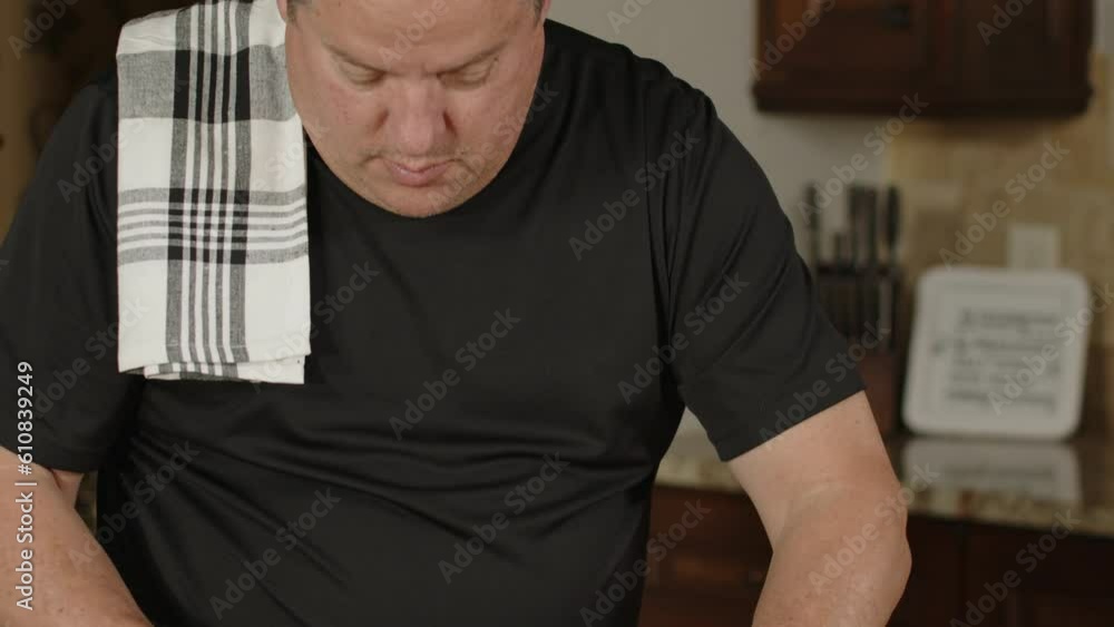 Man removing silver skin on ribs he's preparing to BBQ. Slow motion ...