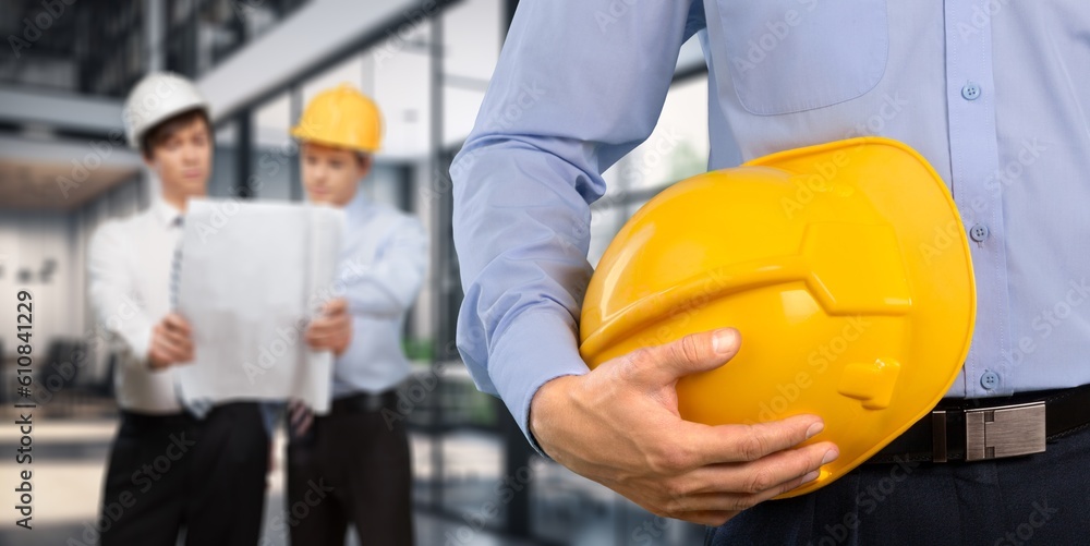 Young smart construction worker at work in office Young smart construction worker at work in office