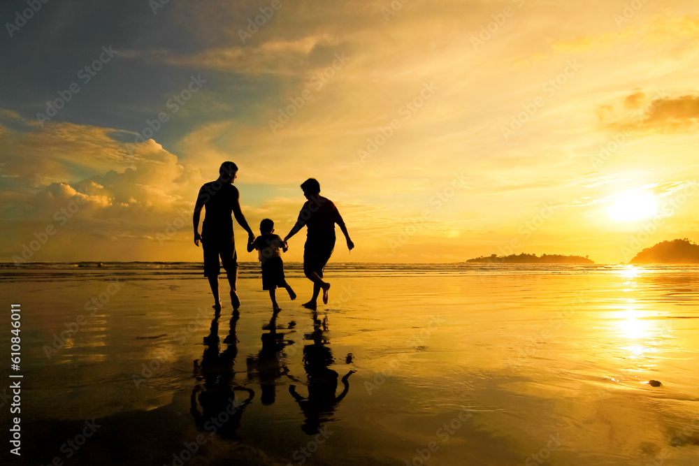 silhouette of a little family on the beach
