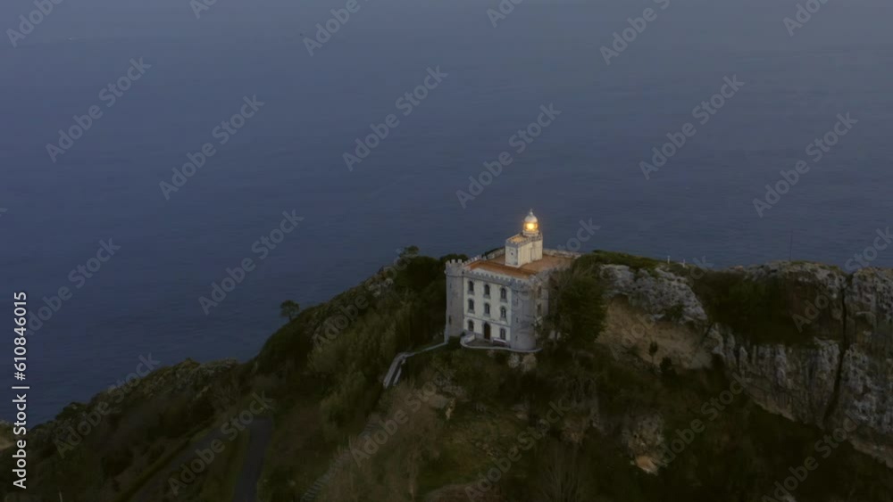 Aerial slow motion orbit around 'El Faro de la Plata' lighthouse on a cliff. Stunning view of sea, horizon, and glorious sky. Pasaia, Gipuzkoa, Spain. Aerial slow motion orbit around 'El Faro de la Plata' lighthouse on a cliff. Stunning view of sea, horizon, and glorious sky. Pasaia, Gipuzkoa, Spain.