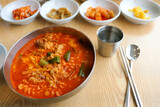 Yukgaejang soup (Spicy Beef Soup with Vegetables) in a bowl this is korean traditional soup with appetizer salads