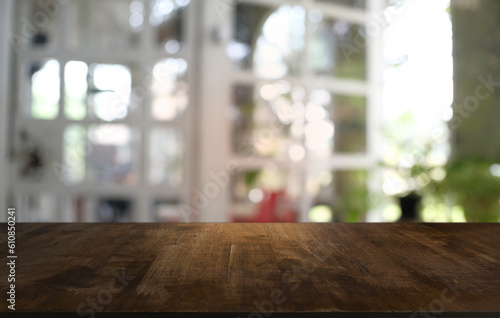 Empty wooden table in front of abstract blurred background of coffee shop . can be used for display or montage your products.Mock up for display © Charlie's