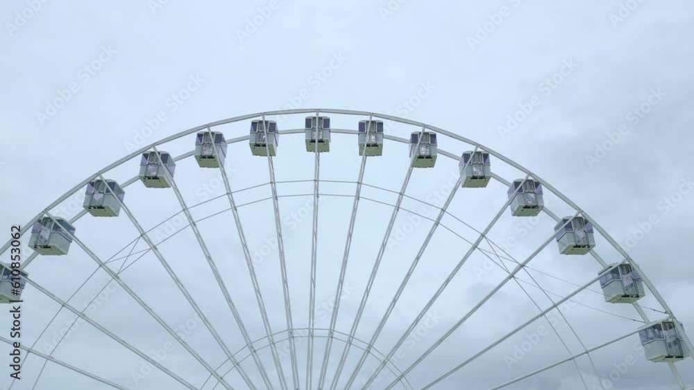 Flying closely over Eastbourne Giant Ferris Wheel. See front and white rocks on the background. Video shot with dji mini 3 pro drone in Eastbourne England. 4K video Flying closely over Eastbourne Giant Ferris Wheel. See front and white rocks on the background. Video shot with dji mini 3 pro drone in Eastbourne England. 4K video