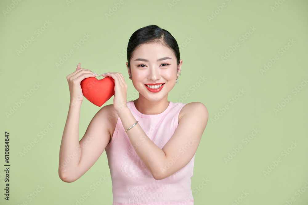 Asian woman with red heart on white background Asian woman with red heart on white background
