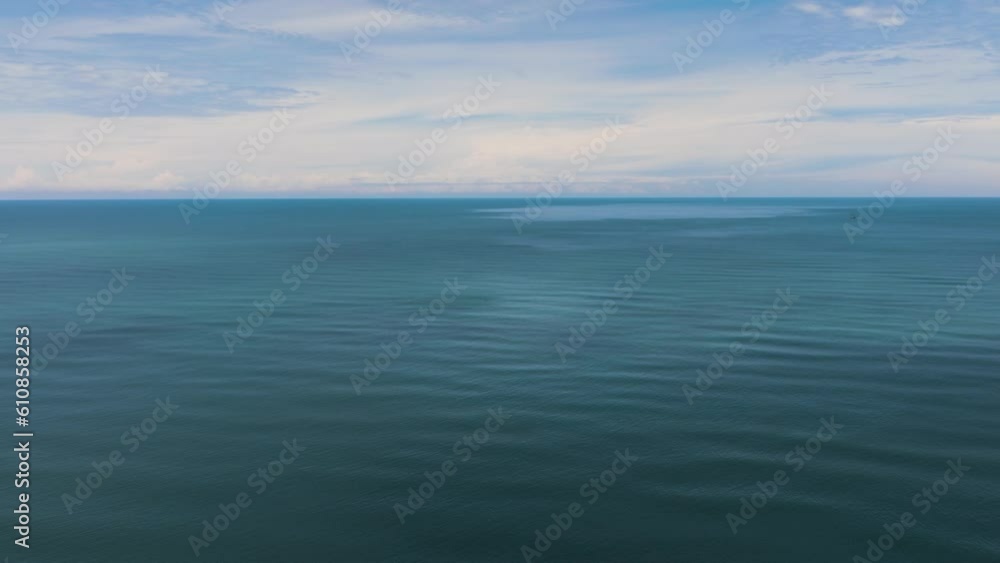 Open blue sea with waves against the sky and clouds. Seascape in the tropics. Borneo, Malaysia. Open blue sea with waves against the sky and clouds. Seascape in the tropics. Borneo, Malaysia.