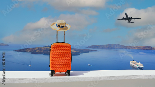 Fototapeta Naklejka Na Ścianę i Meble -  The travel concept with Orange luggage and hat as landscape view of Oia town in Santorini island in Greece , Greek landscape as blue sky background