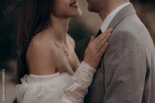 Happy couple having photoshoot outdoors, kissing.