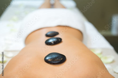 hot stone on back of woman