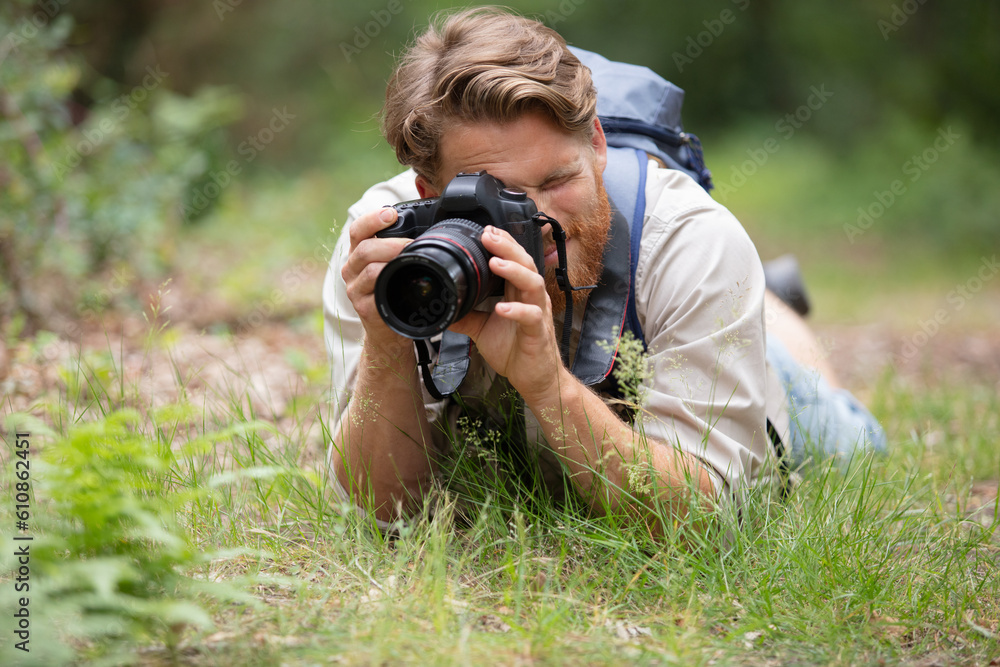 closeup of young man with digital camera outdoors closeup of young man with digital camera outdoors