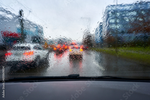 Raindrops on the windshield. Rush hour traffic in the city. Traffic jam.