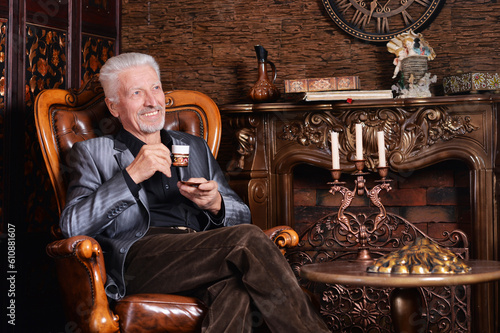 smiling senior man drinking coffee at home